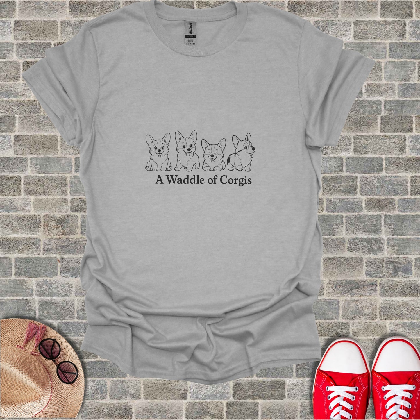 Grey t-shirt with a minimalist line drawing of five corgis and the text "A Waddle of Corgis".