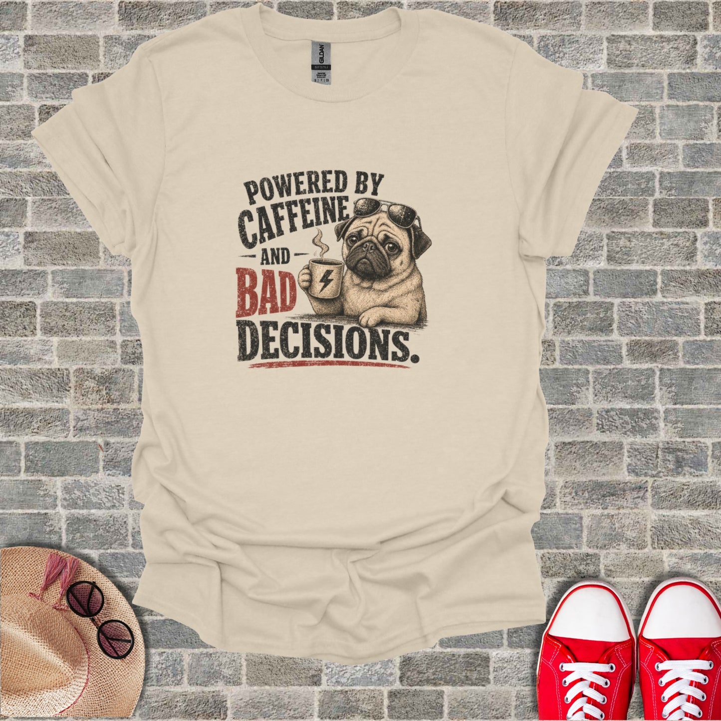 Cream t-shirt with pug in sunglasses holding coffee and text "Powered by Caffeine and Bad Decisions."