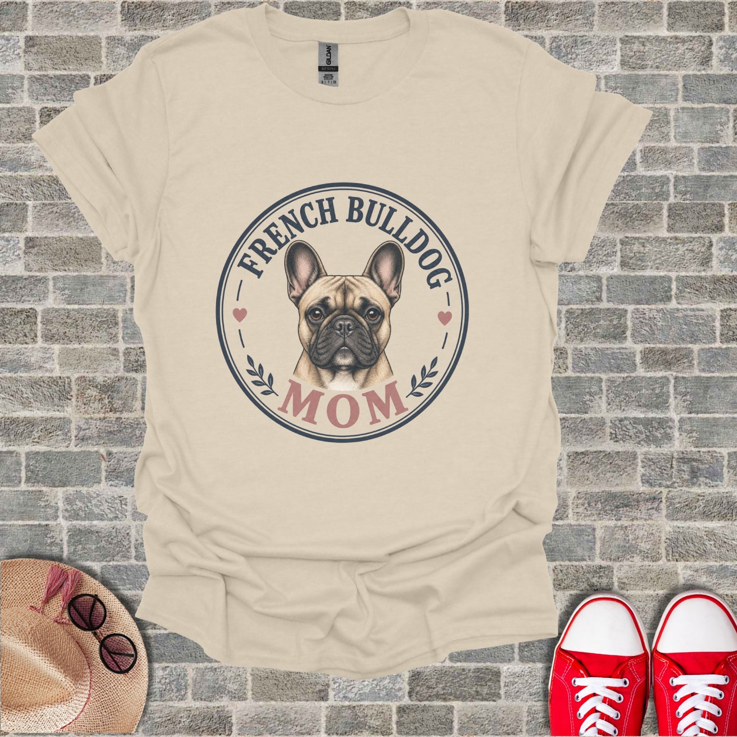 French Bulldog Mom graphic on a cream t-shirt with a straw hat and red shoes.