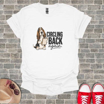 White t-shirt with basset hound holding a clipboard and "Circling Back Again" text.