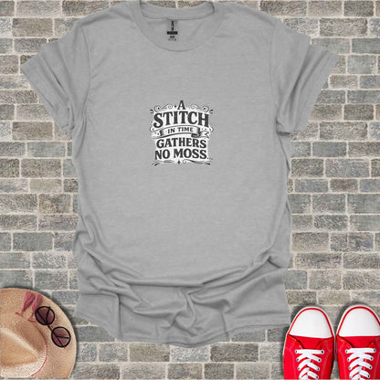 Gray t-shirt with "A stitch in time gathers no moss" text on chest.