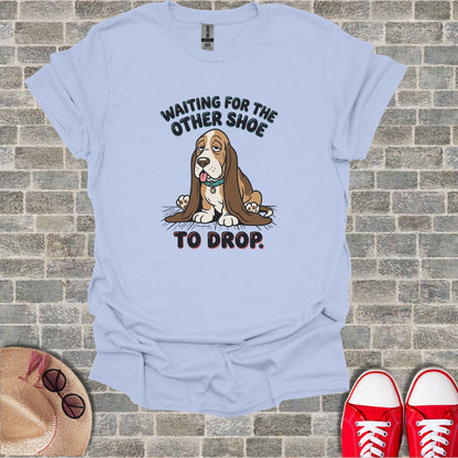 Light blue t-shirt with sad basset hound and text "WAITING FOR THE OTHER SHOE TO DROP."