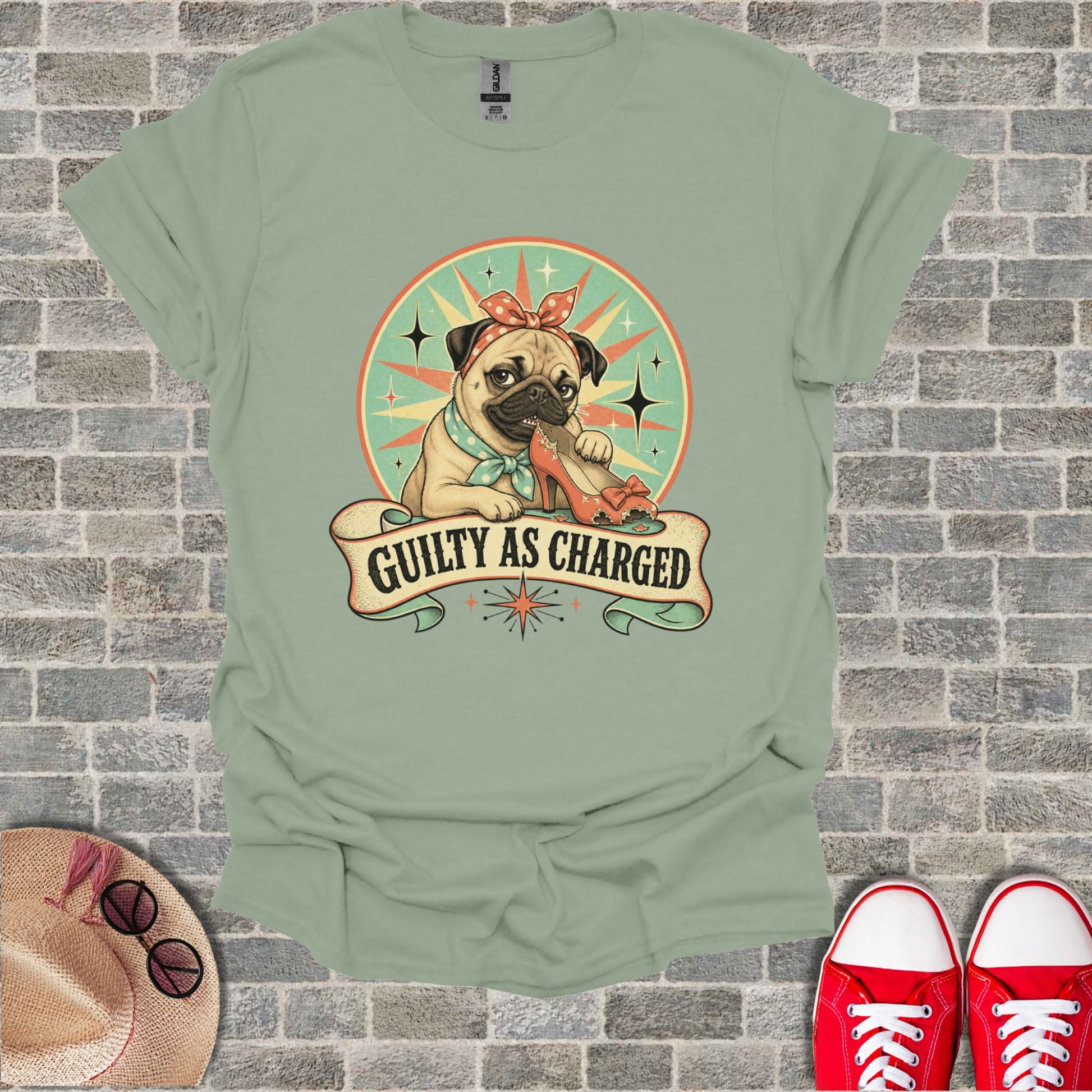 Pug wearing bandana chews shoe with "Guilty As Charged" banner.