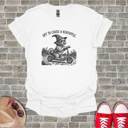 T-shirt with drawing of a dog in a witch hat riding a scooter.