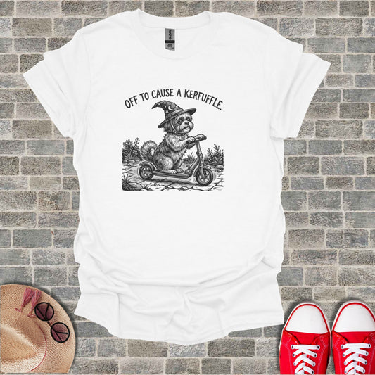 T-shirt with drawing of a dog in a witch hat riding a scooter.
