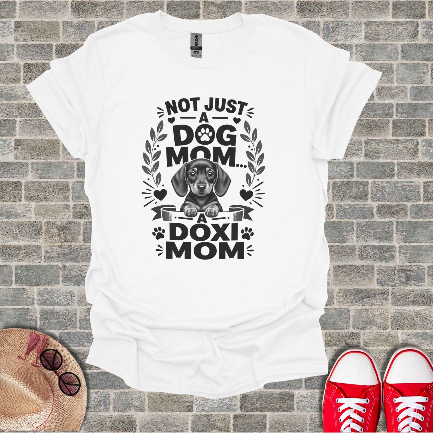 White t-shirt with dachshund graphic and text "NOT JUST A DOG MOM... A DOXI MOM".