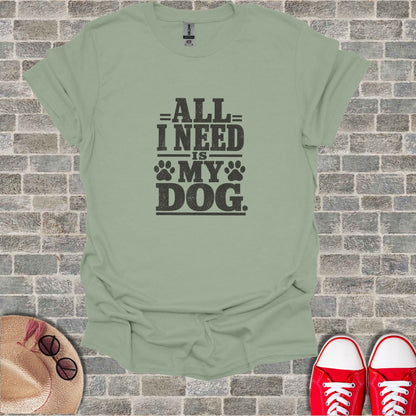 Gray t-shirt with "ALL I NEED IS MY DOG" text and paw prints.