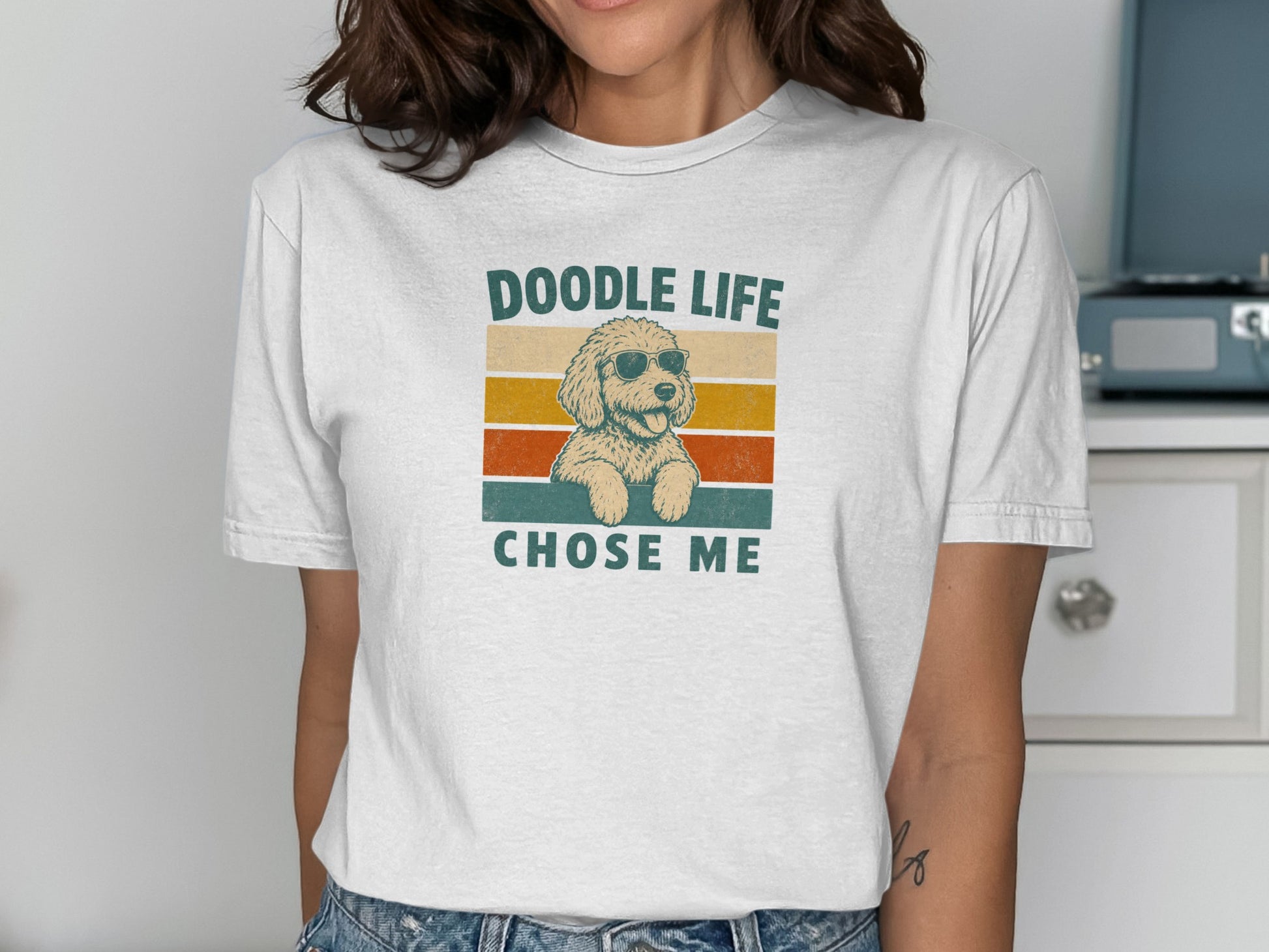 White t-shirt with a doodle wearing sunglasses and text "DOODLE LIFE CHOSE ME".