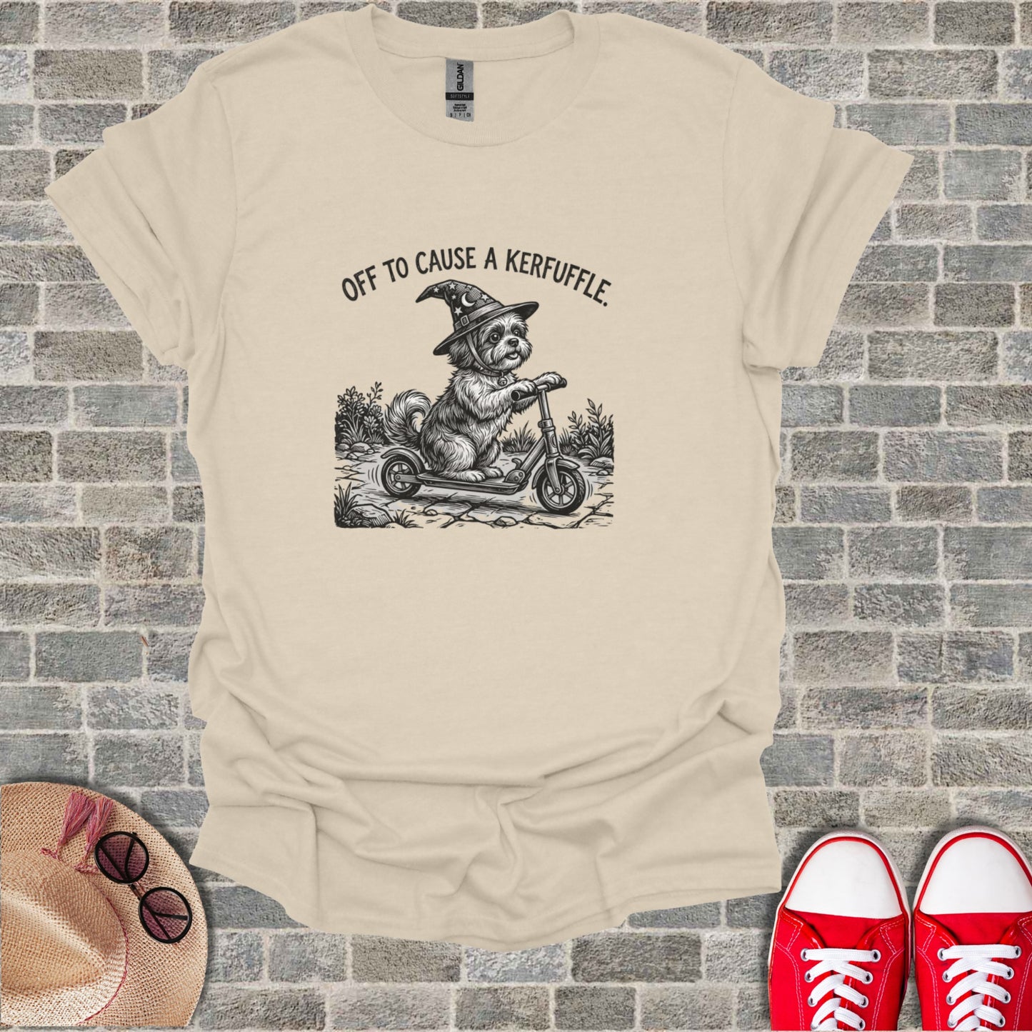 Dog in witch hat riding a scooter with text "Off to Cause a Kerfuffle."