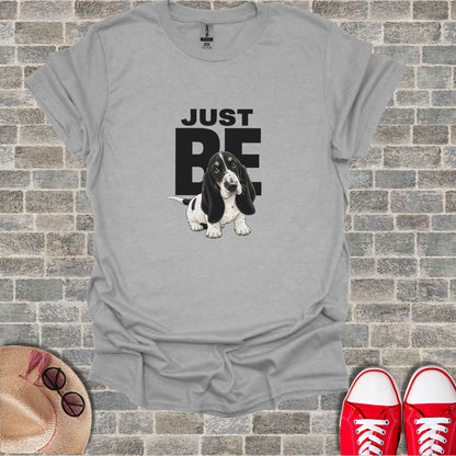 Gray t-shirt with "JUST BE" text and a basset hound dog illustration.