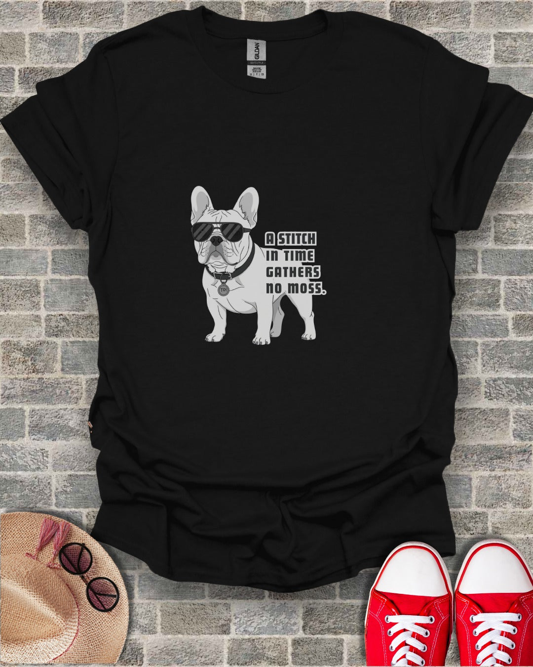 French bulldog wearing sunglasses with text "A stitch in time gathers no moss".