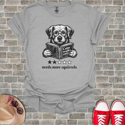T-shirt with a dog wearing glasses reading a book, text reads "Calm walks only needs more squirrels".