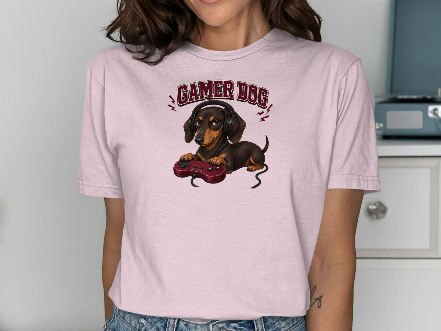 Dachshund wearing headphones and holding a video game controller.