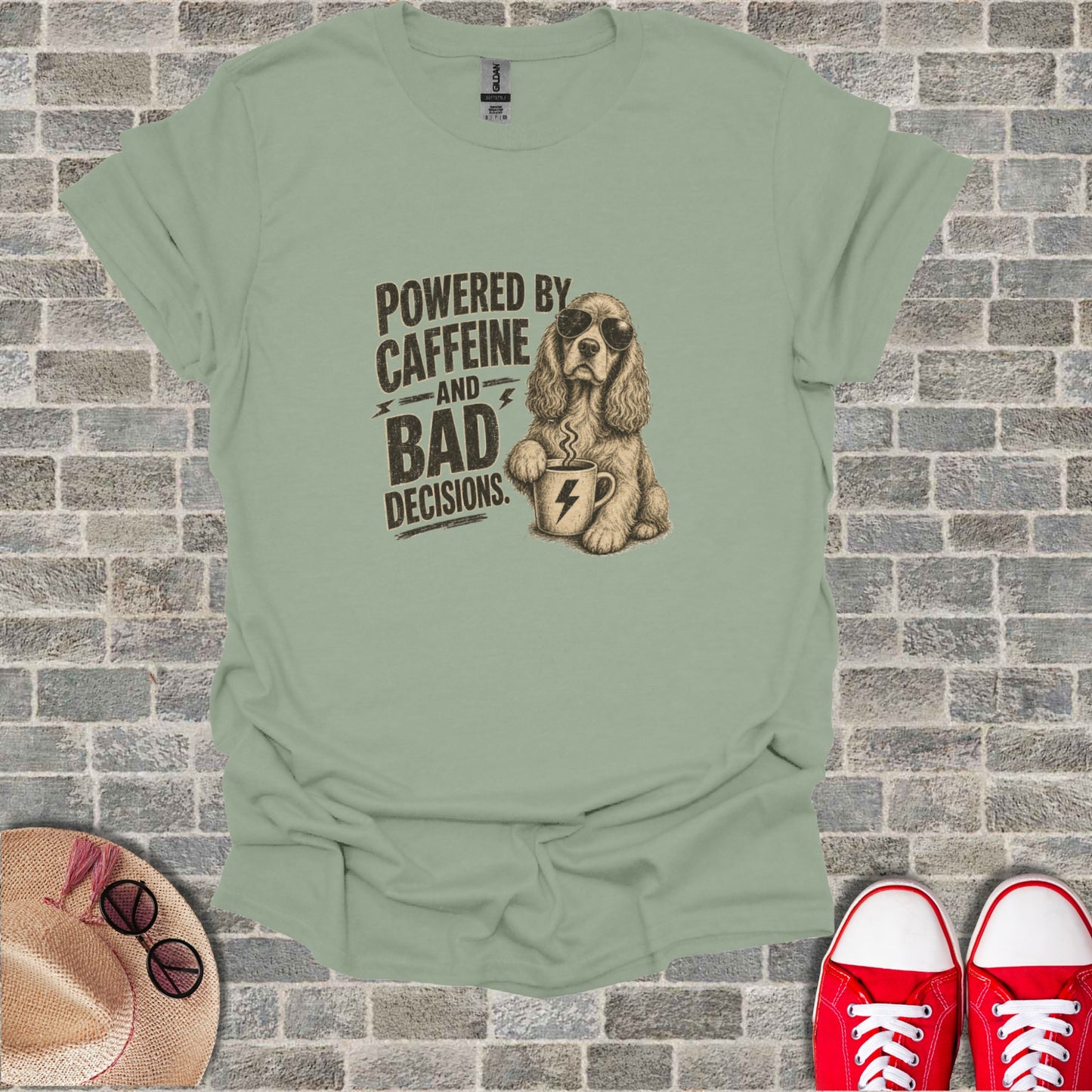 T-shirt with graphic of dog wearing sunglasses drinking coffee, text reads "Powered by caffeine and bad decisions."