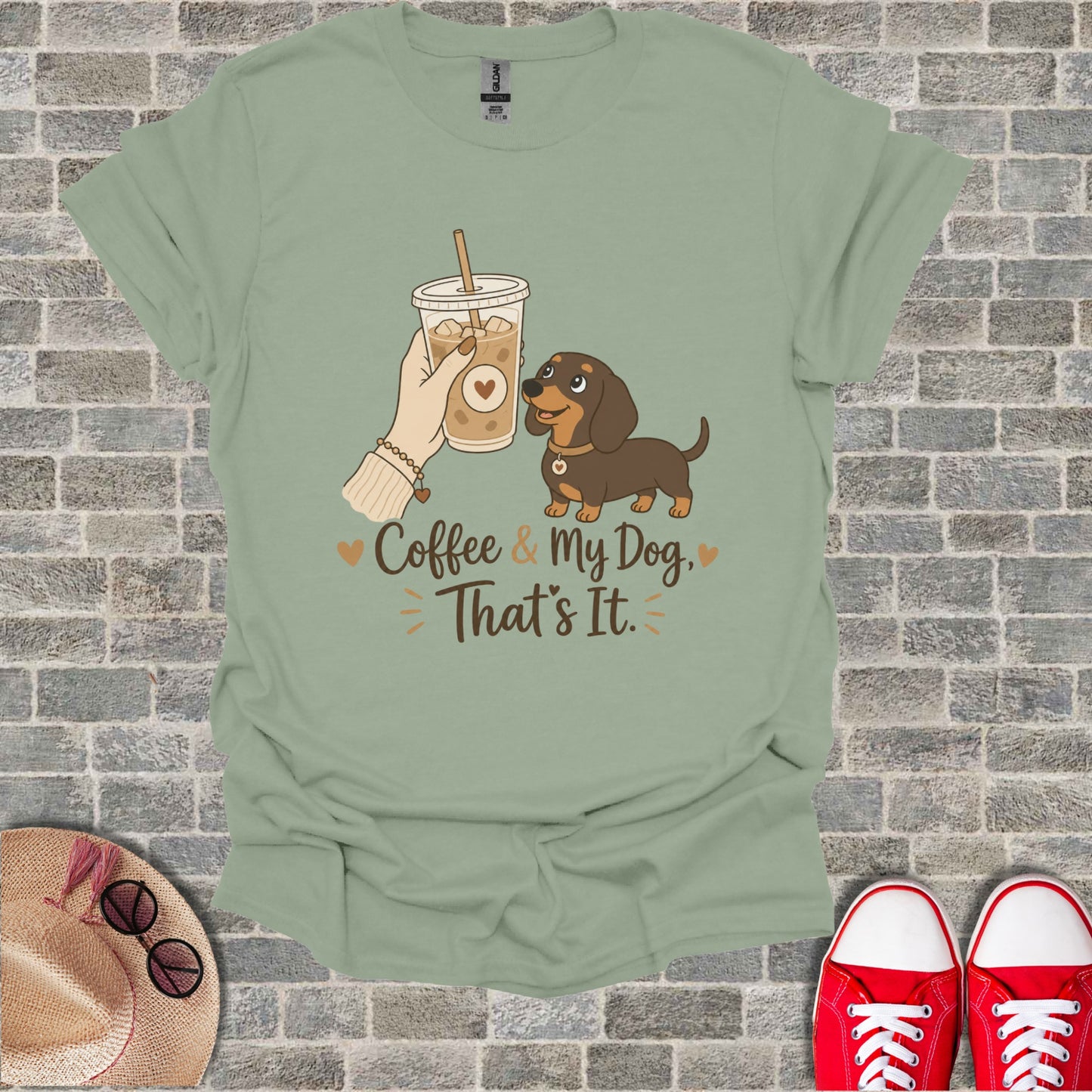 Light green t-shirt with dachshund and coffee cup graphic and text.
