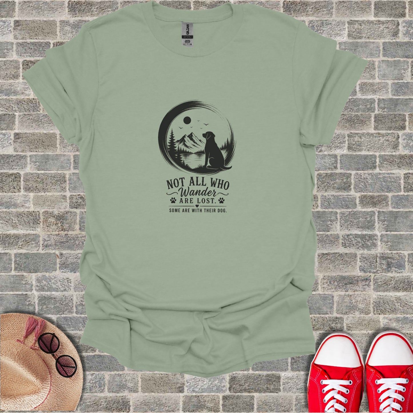 T-shirt with black graphic of dog on mountain, reading "Not All Who Wander Are Lost."
