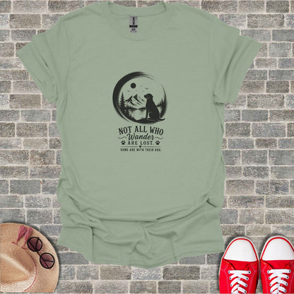 T-shirt with black graphic of dog on mountain, reading "Not All Who Wander Are Lost."
