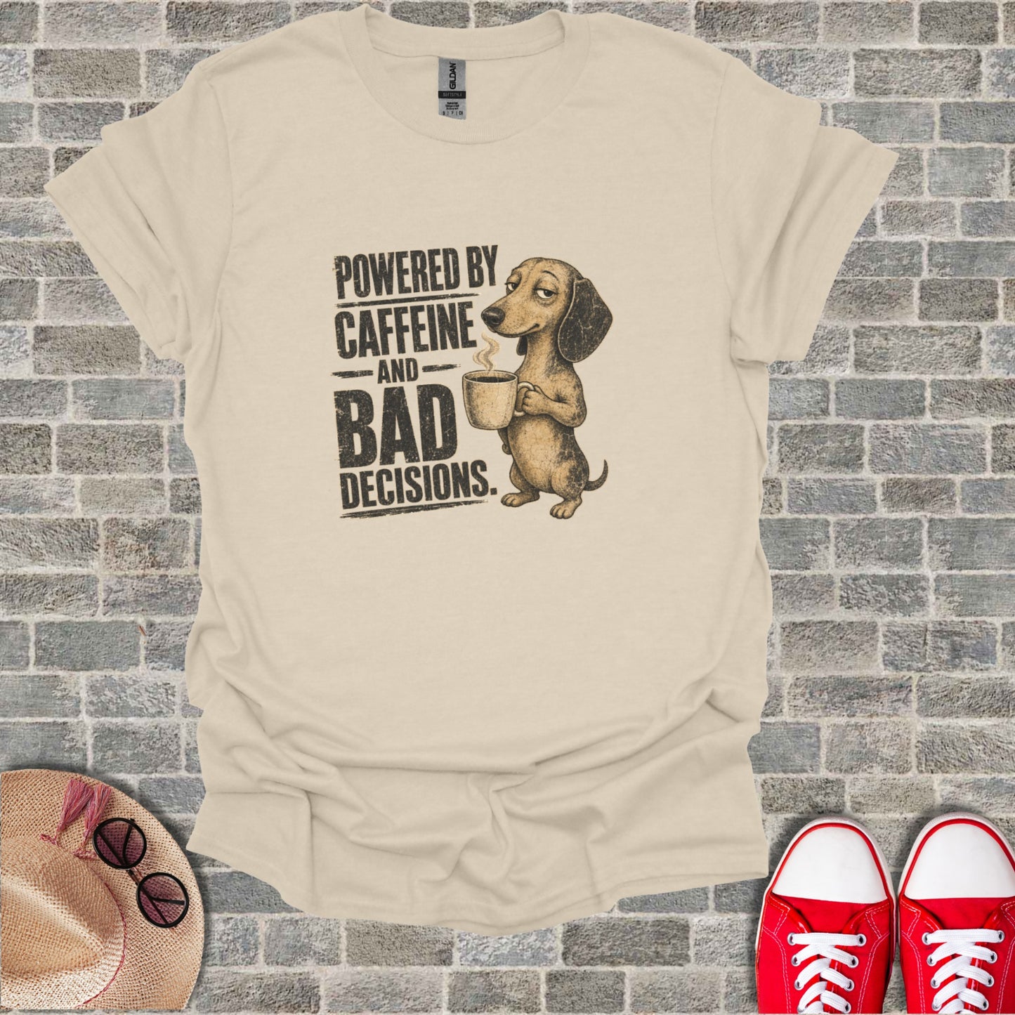 T-shirt with a dachshund holding a coffee cup and text "POWERED BY CAFFEINE AND BAD DECISIONS."
