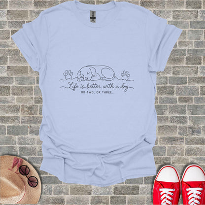 Light blue t-shirt with a sleeping dog graphic and text "Life is better with a dog or two, or three..."