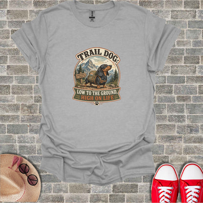 Gray t-shirt with "Trail Dog: Low to the Ground, High on Life" text and illustration.