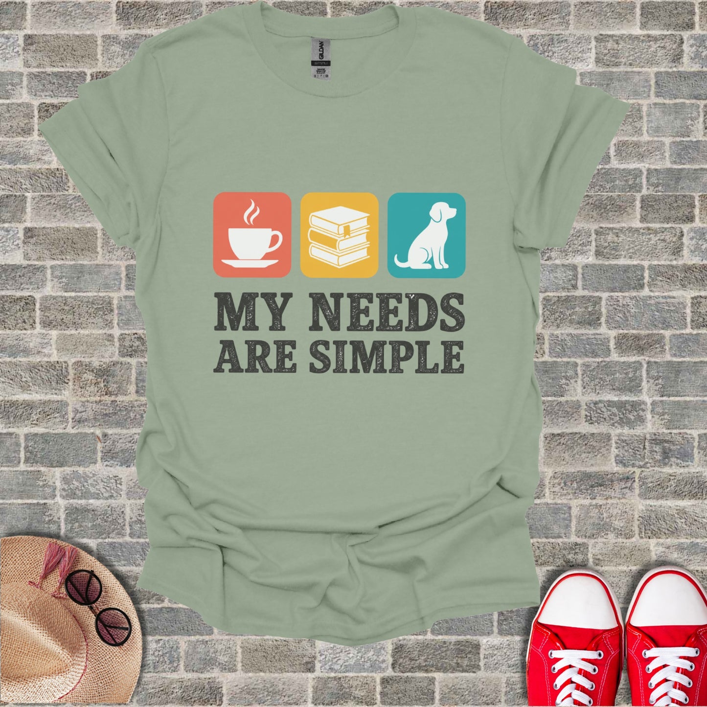 T-shirt with icons of coffee, books, dog, and text "MY NEEDS ARE SIMPLE".