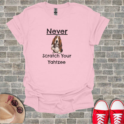 Pink t-shirt with "Never Scratch Your Yahtzee" text and a dog wearing glasses.