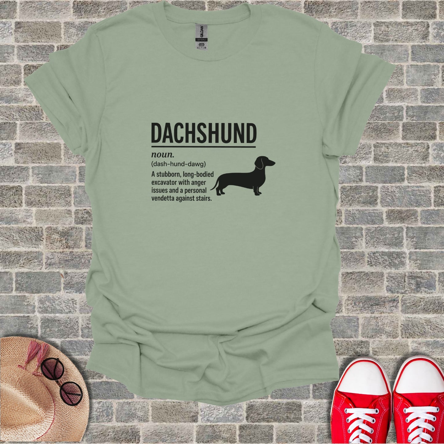 Dachshund definition tee with silhouette on a light green t-shirt.