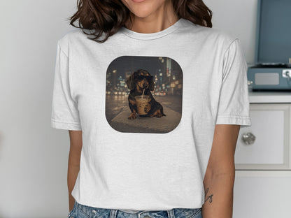 Dachshund wearing sunglasses drinks from iced coffee with blurry city lights background.