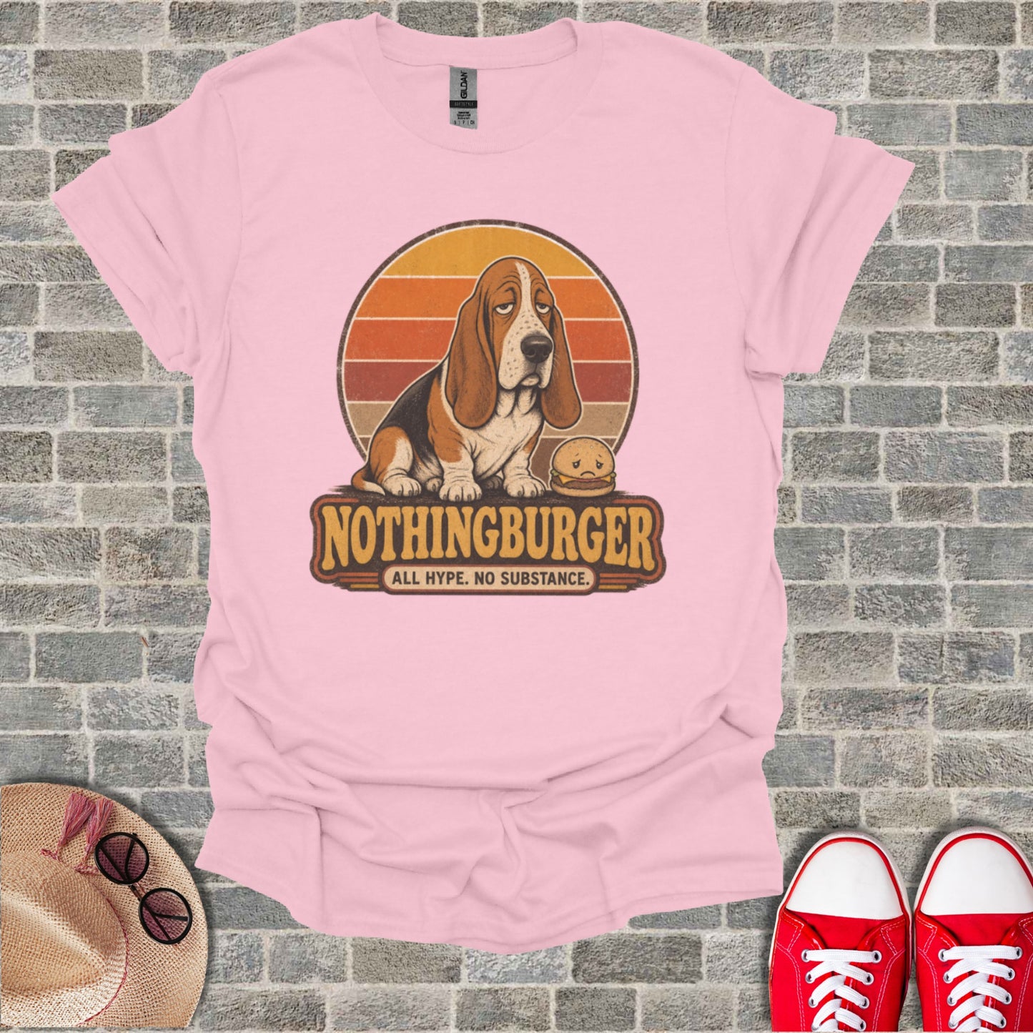 Basset hound with hamburger wearing shirt with text "NOTHINGBURGER ALL HYP. NO SUBSTANCE."