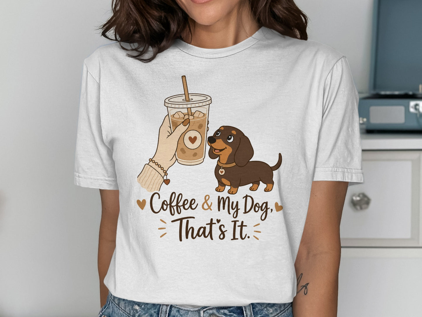 White t-shirt with cartoon dachshund, iced coffee cup, and text "Coffee & My Dog, That's It."