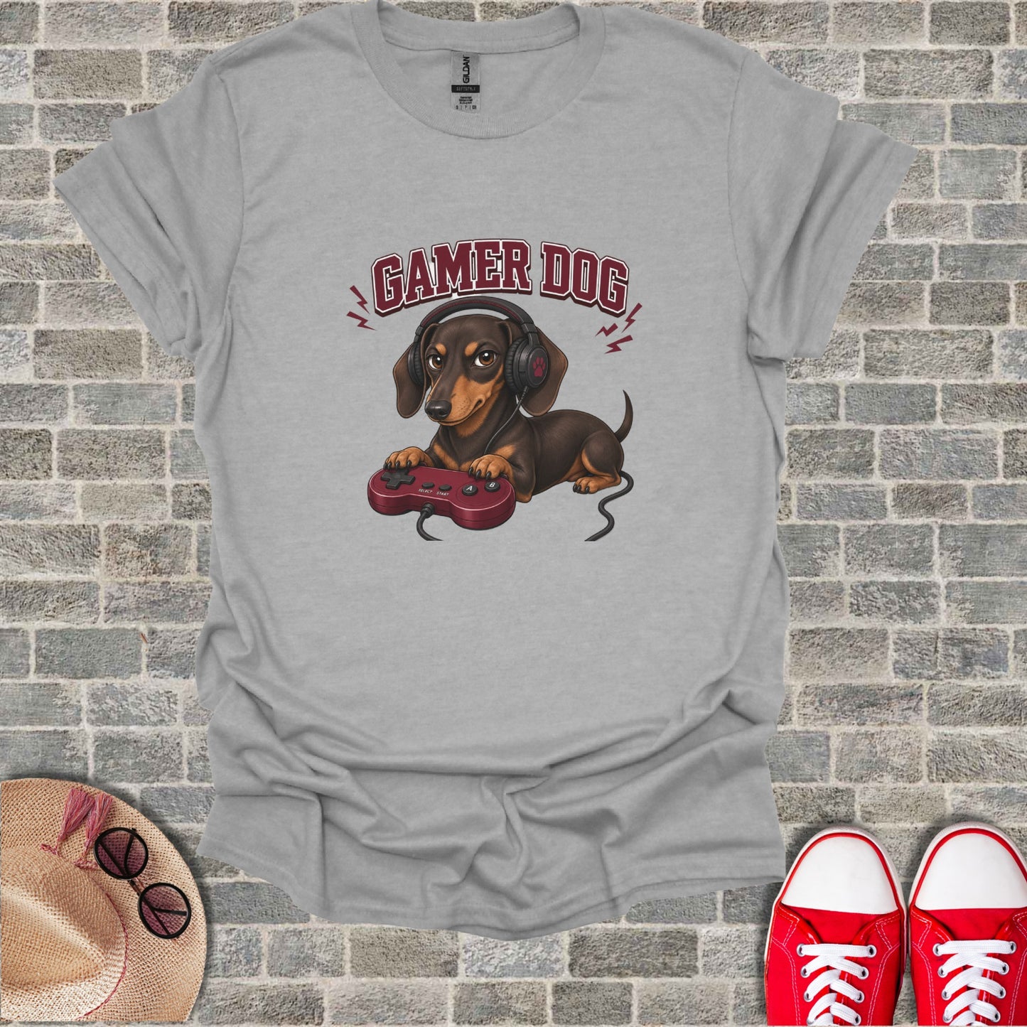 T-shirt with graphic of a brown dog wearing headphones and holding a video game controller.