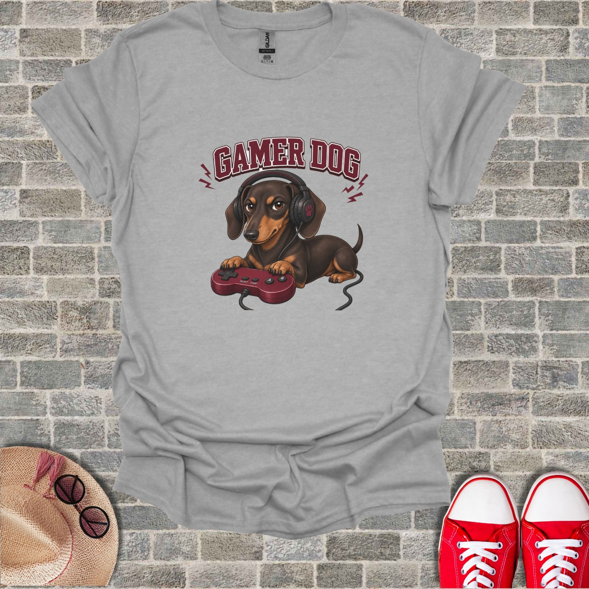 T-shirt with graphic of a brown dog wearing headphones and holding a video game controller.
