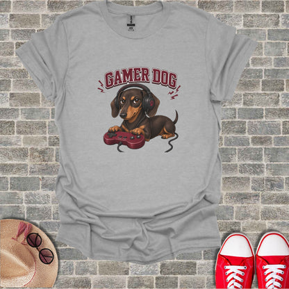 T-shirt with graphic of a brown dog wearing headphones and holding a video game controller.