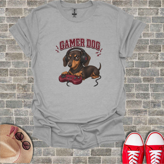 T-shirt with graphic of a brown dog wearing headphones and holding a video game controller.