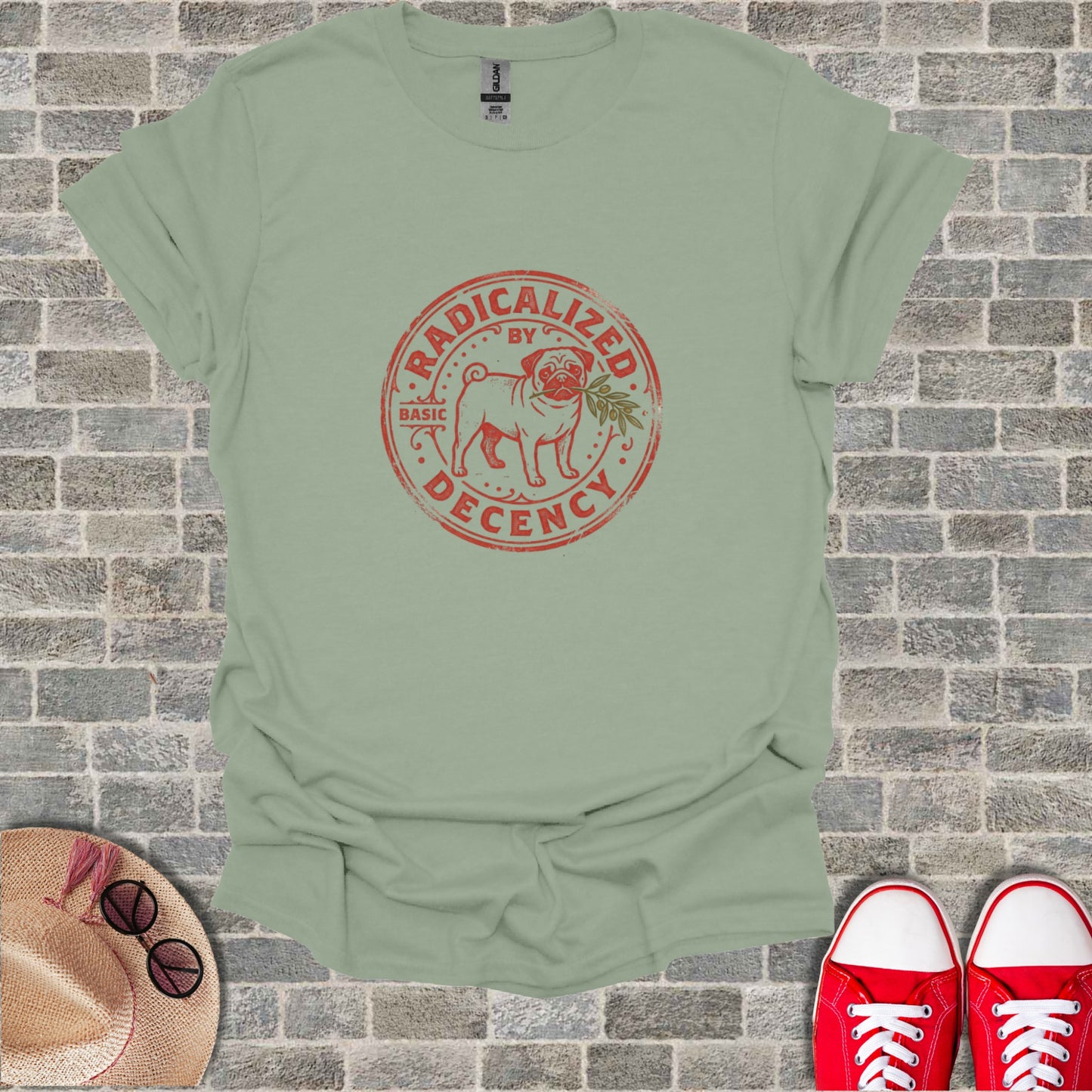 Light green t-shirt with "Radicalized by Basic Decency" text and a leaf emblem.