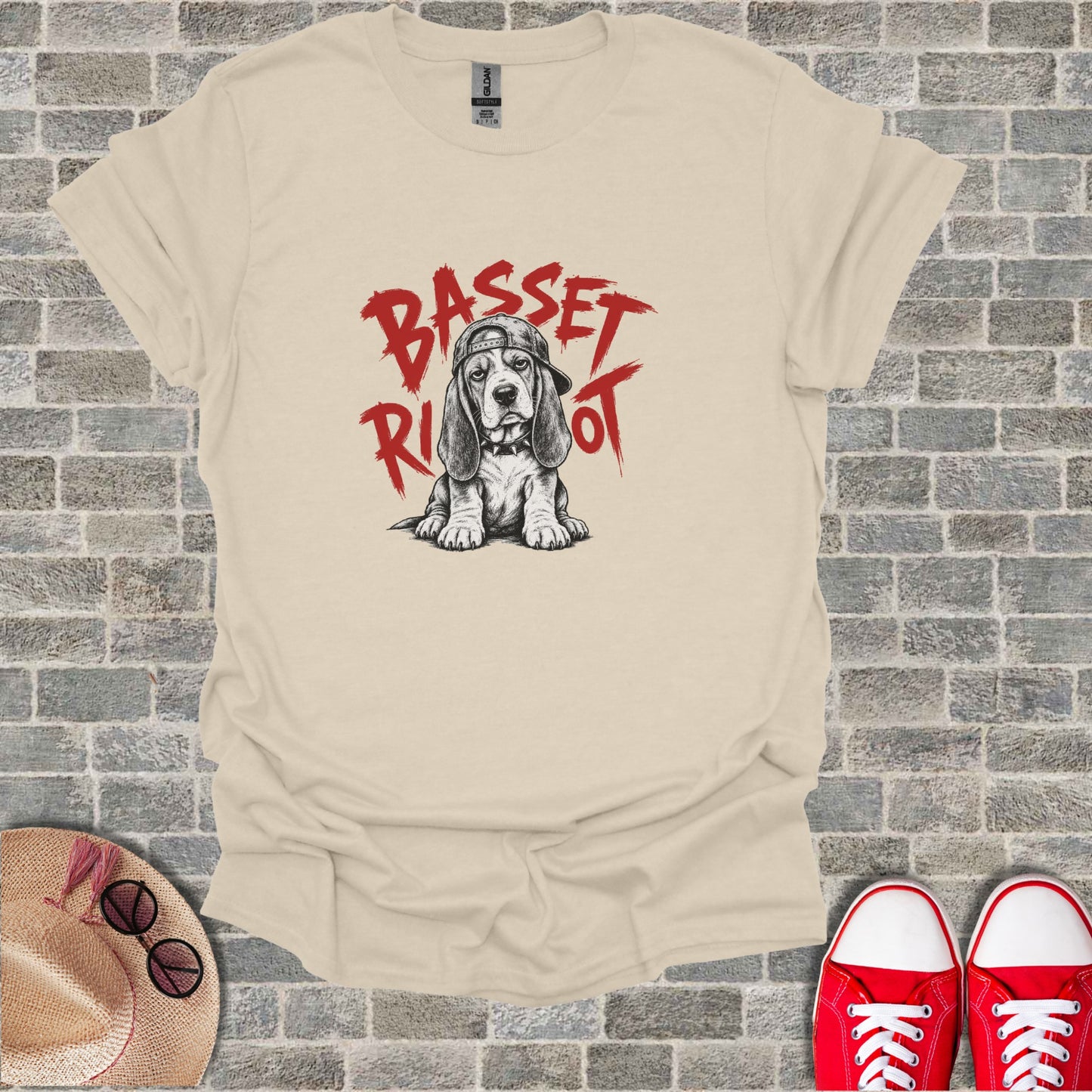 Basset Hound wearing a baseball cap, red text "Basset Riot" above.
