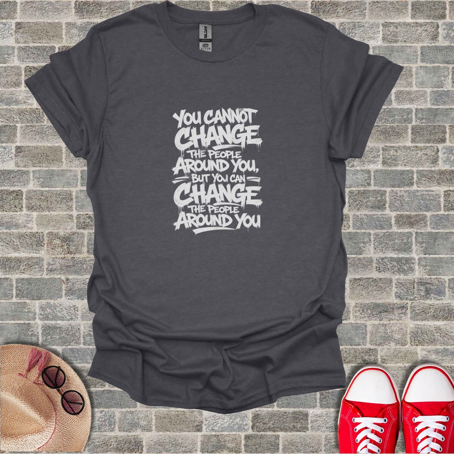 Dark gray t-shirt with white text: "You cannot change the people around you, but you can change the people around you."