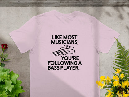 Pink t-shirt with text "Like most musicians, you're following a bass player."