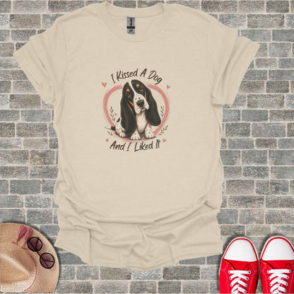 Cream t-shirt with graphic of a Basset Hound and text "I Kissed A Dog And I Liked It".
