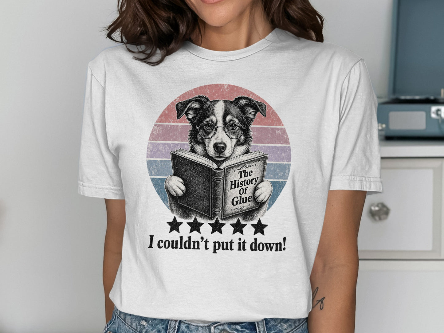 Dog wearing glasses reads "The History of Glue" on a t-shirt.