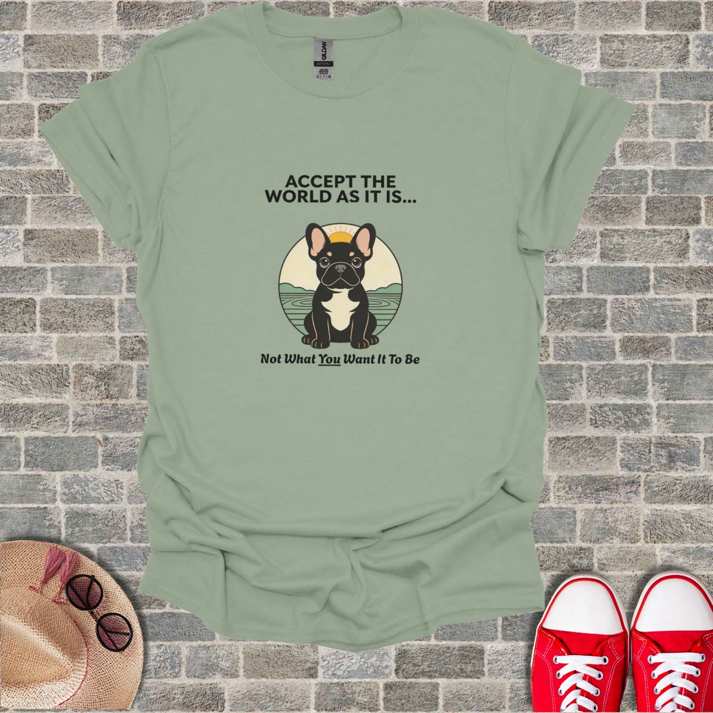 French bulldog sitting with "Accept the world as it is..." text.