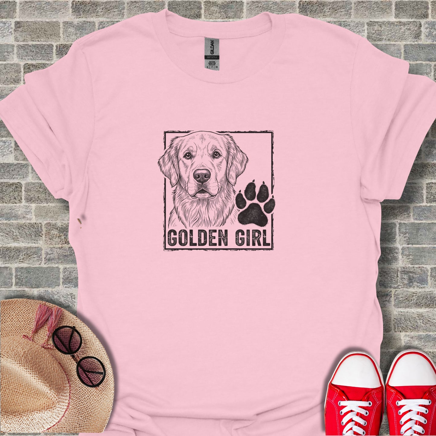 Pink t-shirt with "Golden Girl" and paw print graphic.