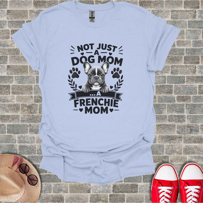Light blue t-shirt with a French Bulldog graphic and text saying "Not just a dog mom... a Frenchie mom".