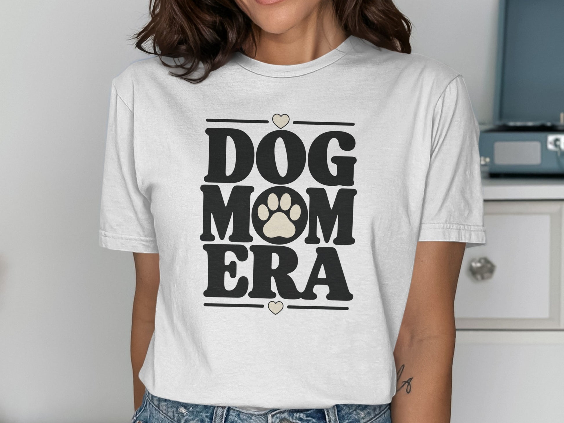 White t-shirt with "DOG MOM ERA" text and paw print logo.