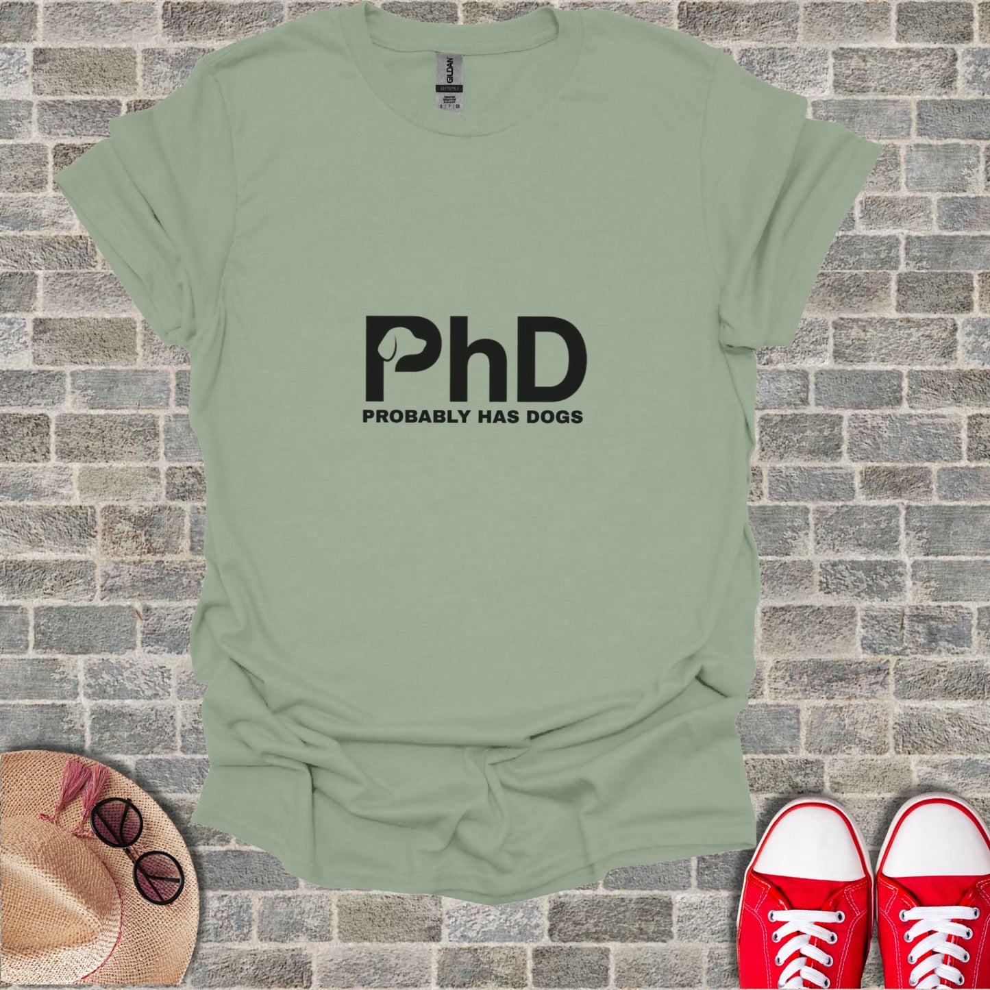 Green t-shirt with "PhD PROBABLY HAS DOGS" text.