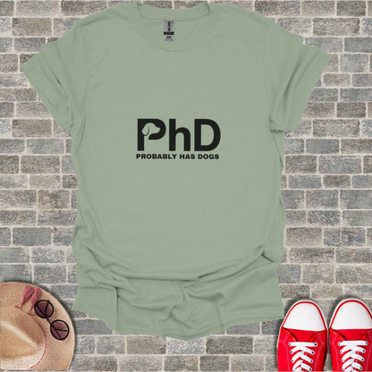 Green t-shirt with "PhD PROBABLY HAS DOGS" text.