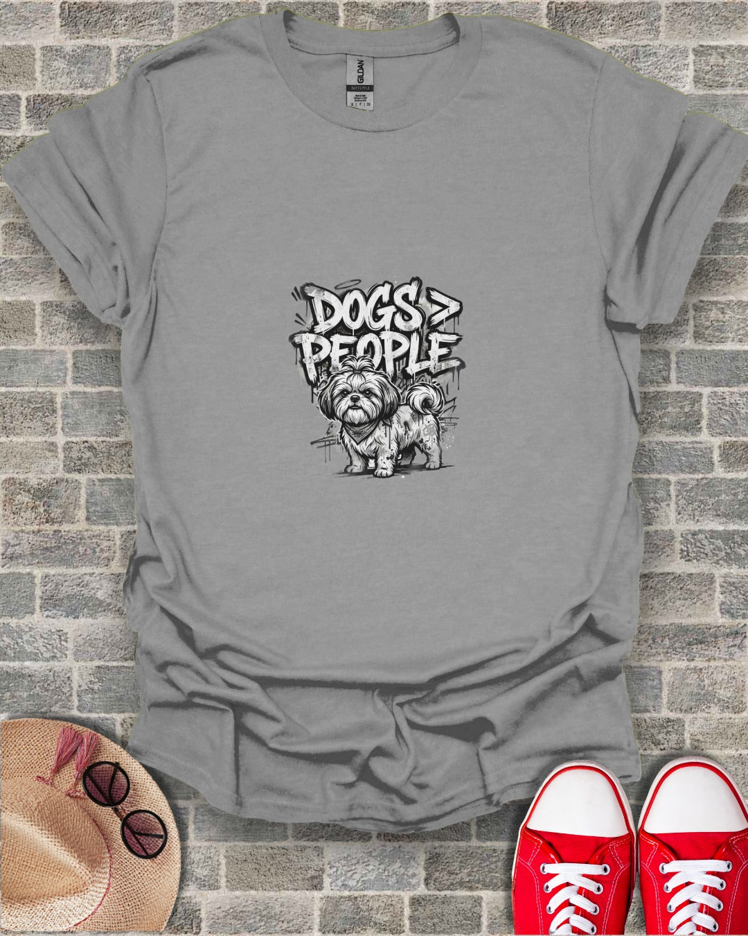 Gray t-shirt with a sketch of a dog and text "Dogs > People".