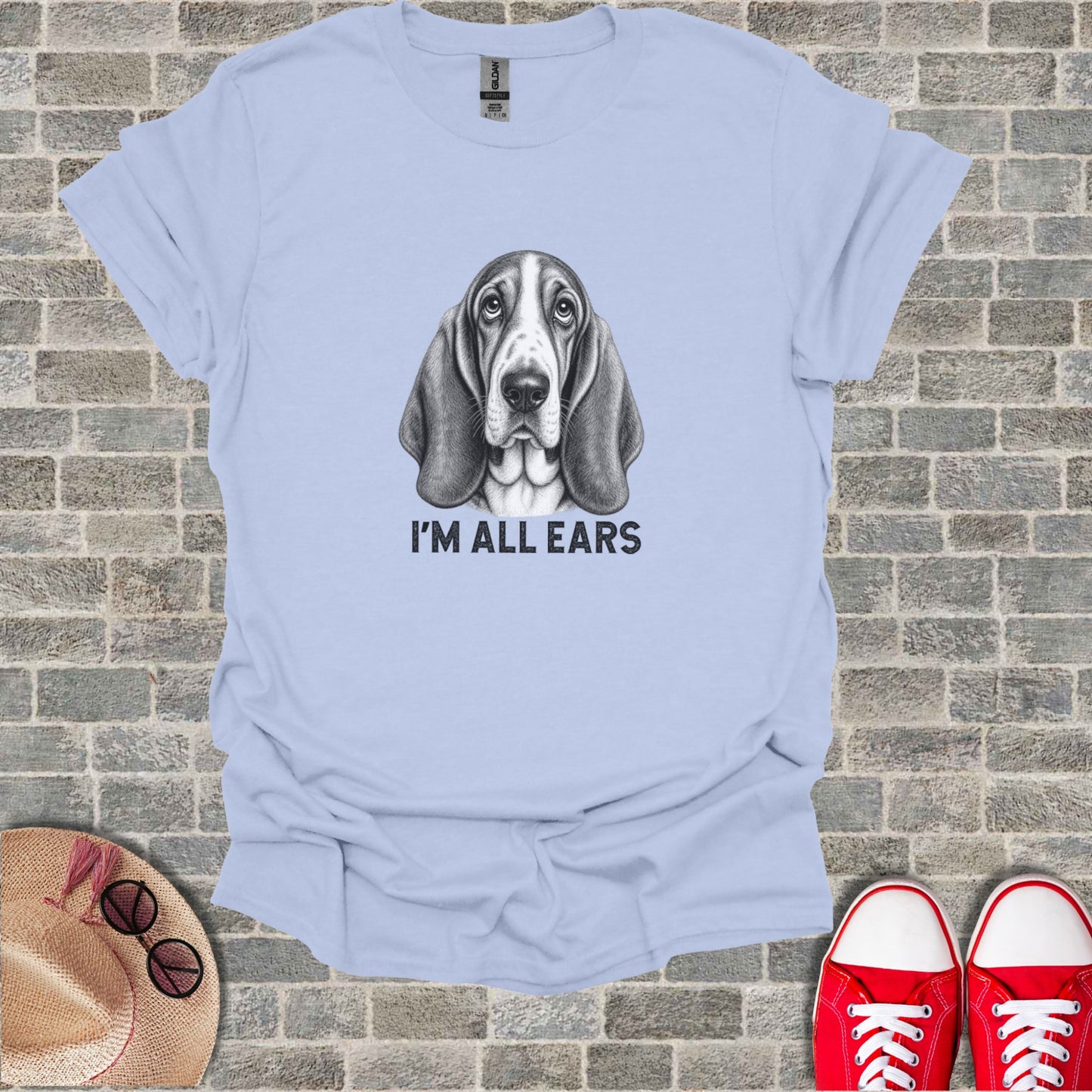 Light blue t-shirt with black and white sketch of a Basset Hound and text "I'M ALL EARS".