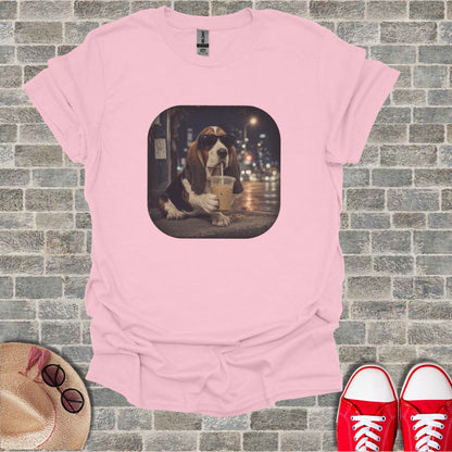 Pink t-shirt with a graphic of a Basset Hound wearing sunglasses drinking iced coffee.