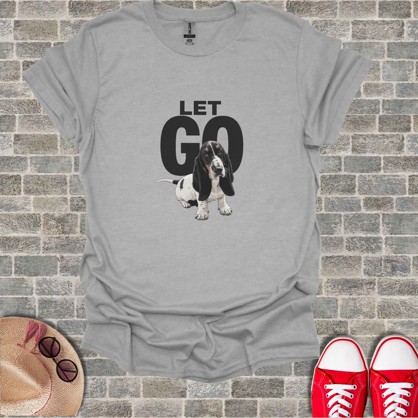 Basset Hound dog graphic with "LET GO" text on a grey t-shirt.